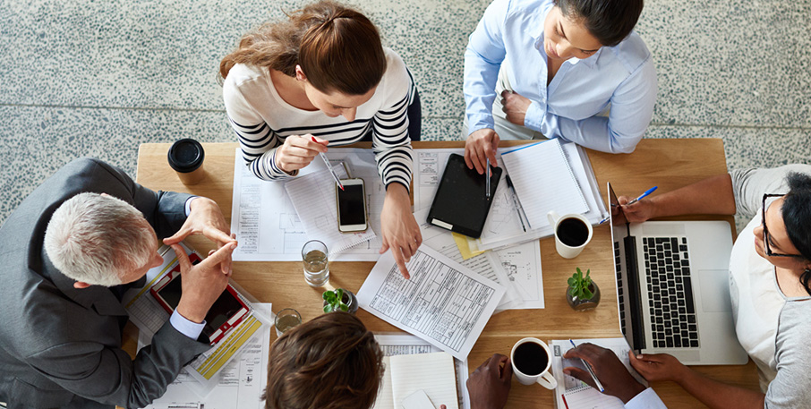 Colleagues collaborate at a table.